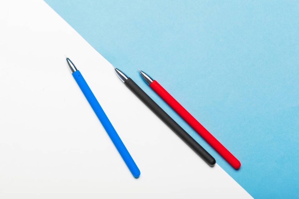 Top view workspace mockup on blue background with notebook, pen